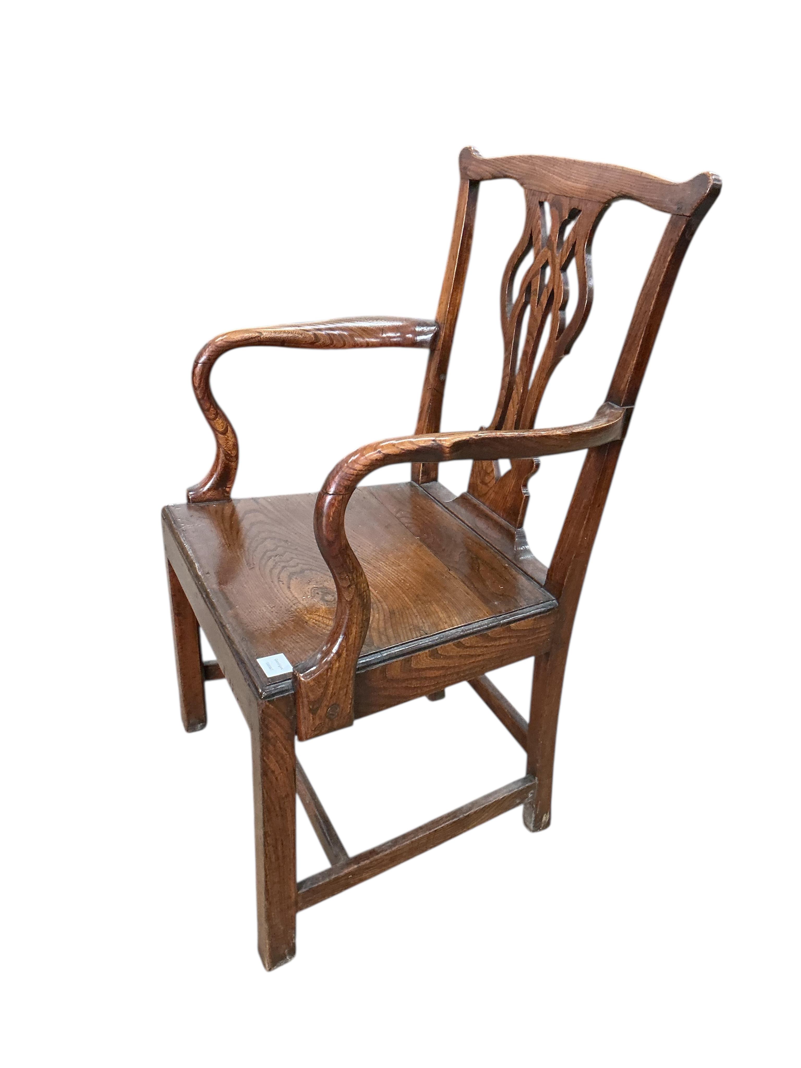 A George III Provincial oak wood seat elbow chair, width 60cm, depth 46cm, height 96cm